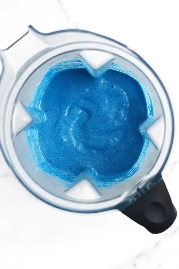 Blue spirulina smoothie in blender after blending