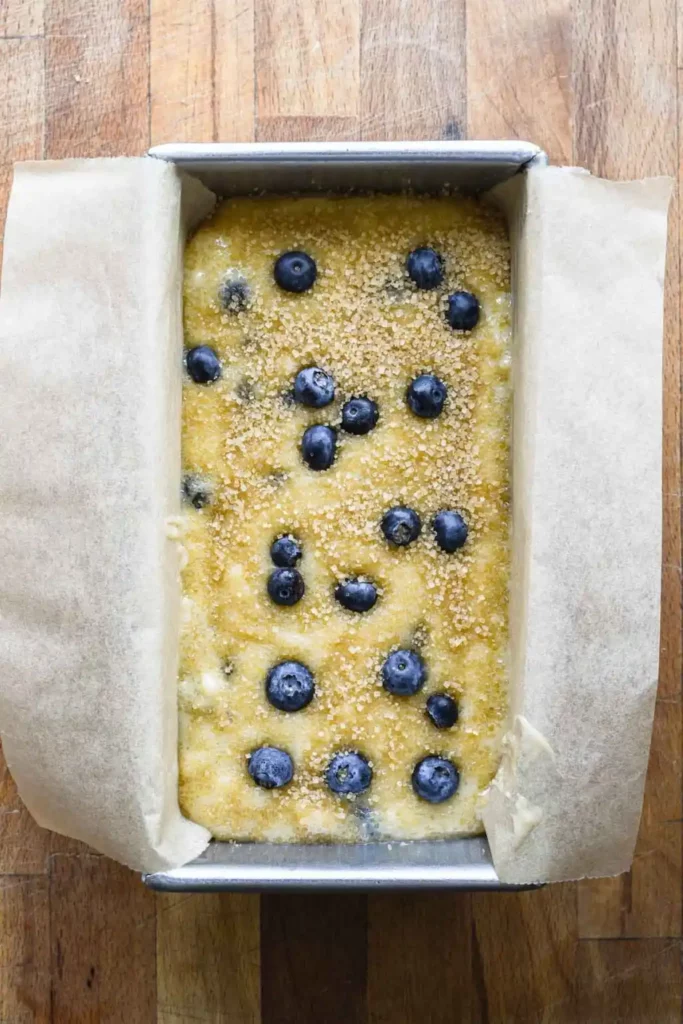 Unbaked blueberry lemon mascarpone cake batter in loaf pan