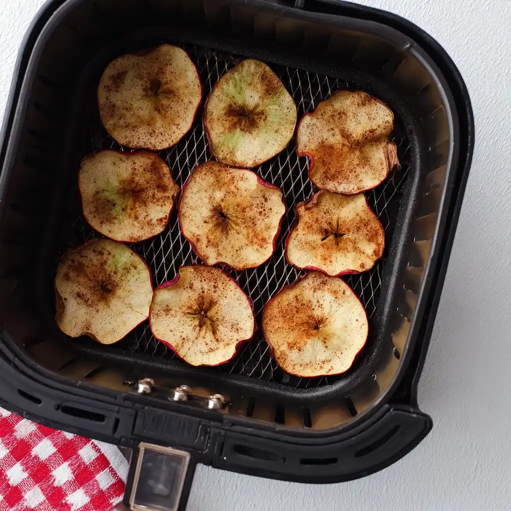 Air fryer apple chips arranged in a single layer