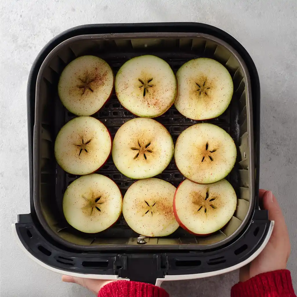 Apple slices arranged in air fryer